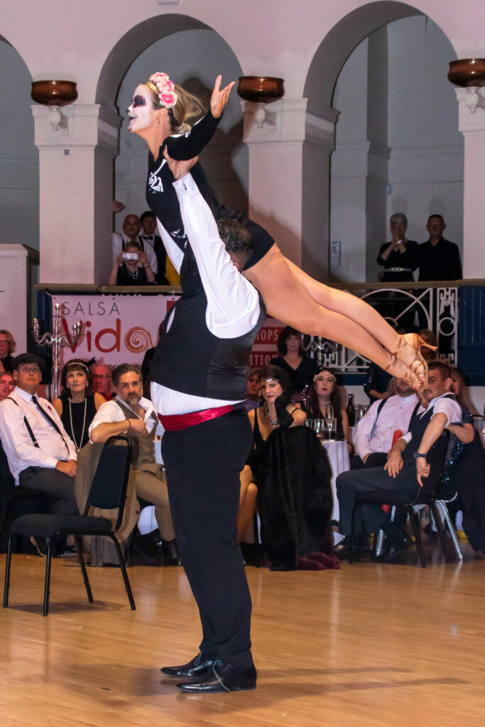 Couple performing a lift in the ballroom at the Winter Gardens to raise money for Weston Hospicecare at a previous Strictly Fun Dancing Grand Finale.