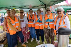 A photo of Weston Hospicecare volunteers helping at the Summer Fayre 2022