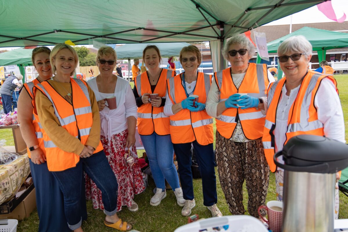 A photo of Weston Hospicecare volunteers helping at the Summer Fayre 2022.
