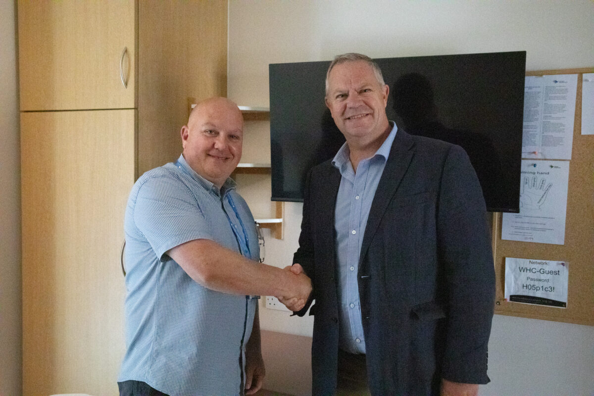 Photo showing Dave Hill, hospice Trusts and Foundations Officer with John Sisman from the Malcolm Gunter Foundation with the new TVs set up in our In-patient rooms.