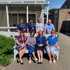 Weston Hospicecare staff photo, showing staff all wearing blue to promote the 'Blue For You' campaign
